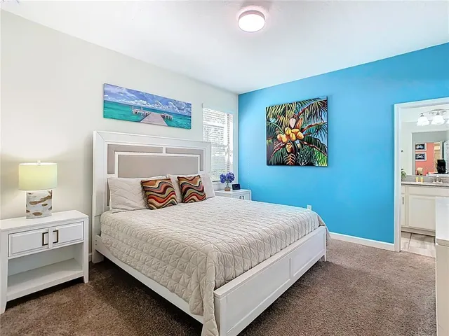 a bedroom with a bed and wall painting
