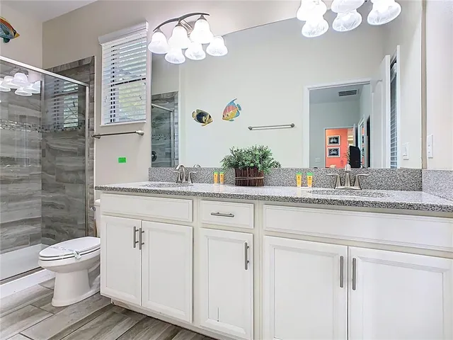 a bathroom with a sink a toilet and a mirror