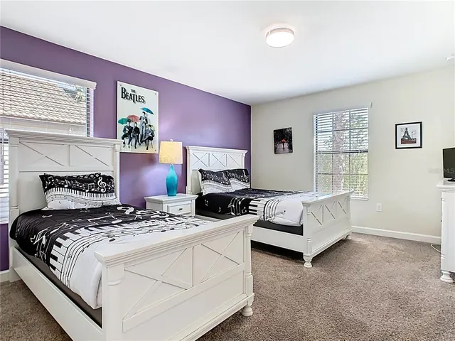 a bedroom with a bed couch and window