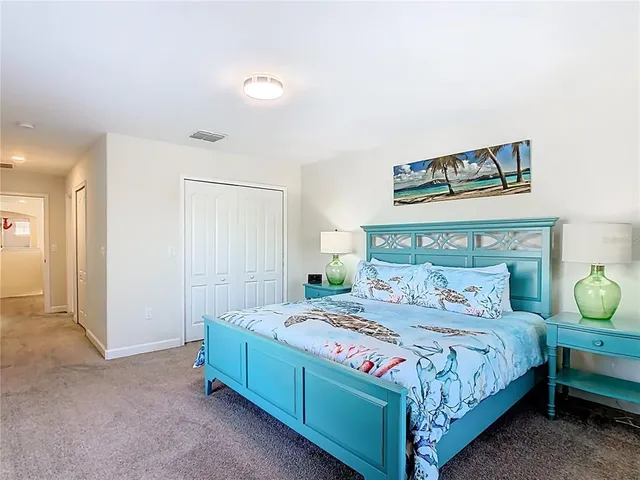 a bedroom with a bed and cabinet