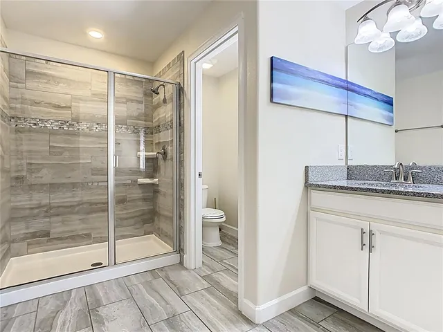 a bathroom with a shower and a sink