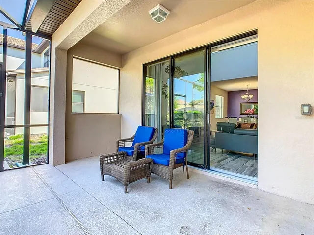 a living room with furniture and a floor to ceiling window
