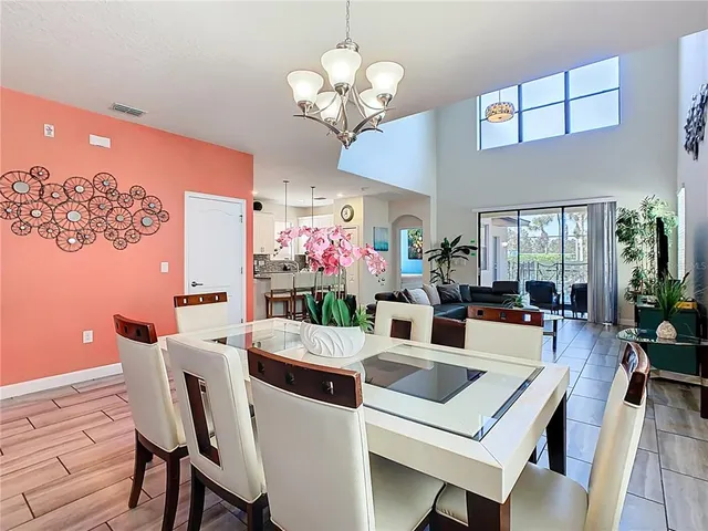 a view of a dining room with furniture and chandelier