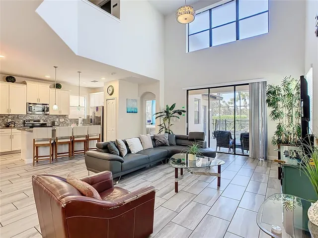 a living room with furniture and a view of kitchen