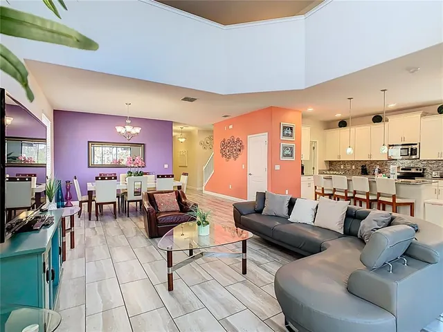 a living room with furniture and a view of kitchen