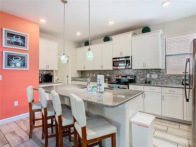 a kitchen with a sink cabinets and wooden floor