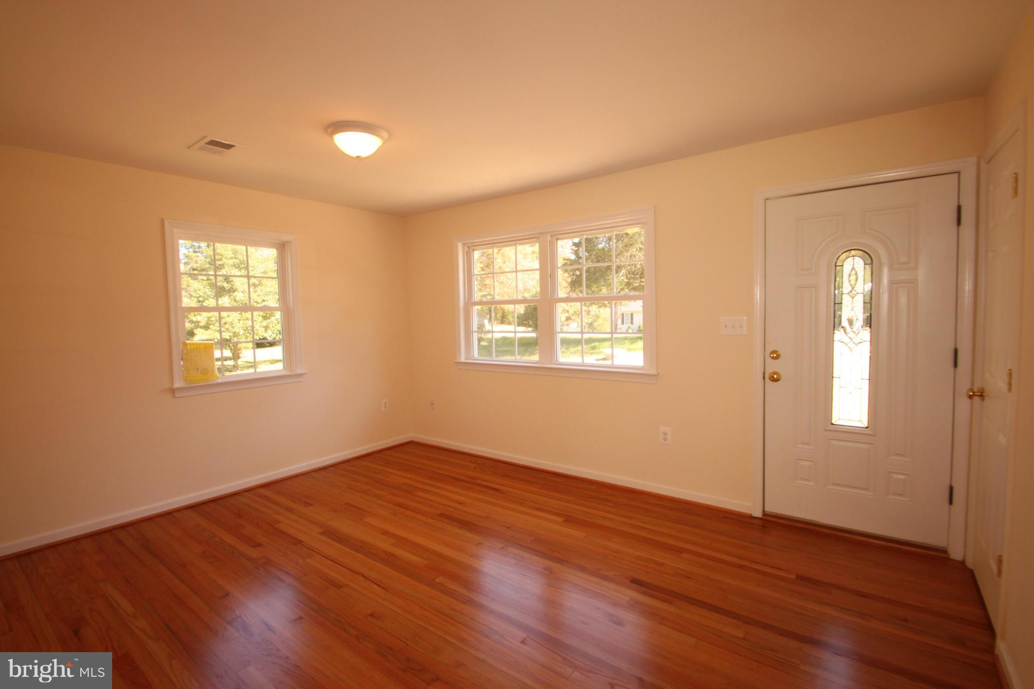 14394 Shanktown Road Reva, VA 22735 - Photo 2 of 18 an empty room with wooden floor and windows