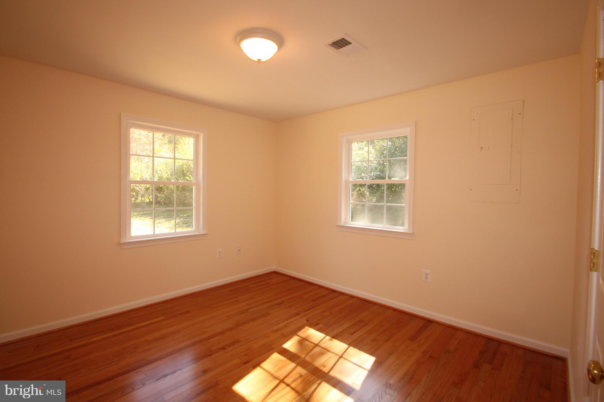 14394 Shanktown Road Reva, VA 22735 - Photo 12 of 18 a view of empty room with wooden floor and fan