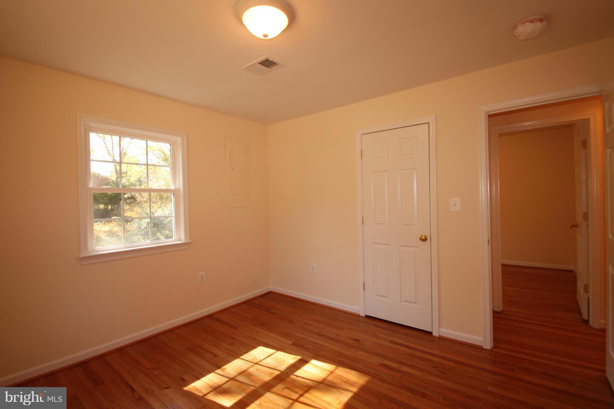14394 Shanktown Road Reva, VA 22735 - Photo 13 of 18 a view of an empty room with wooden floor and a window