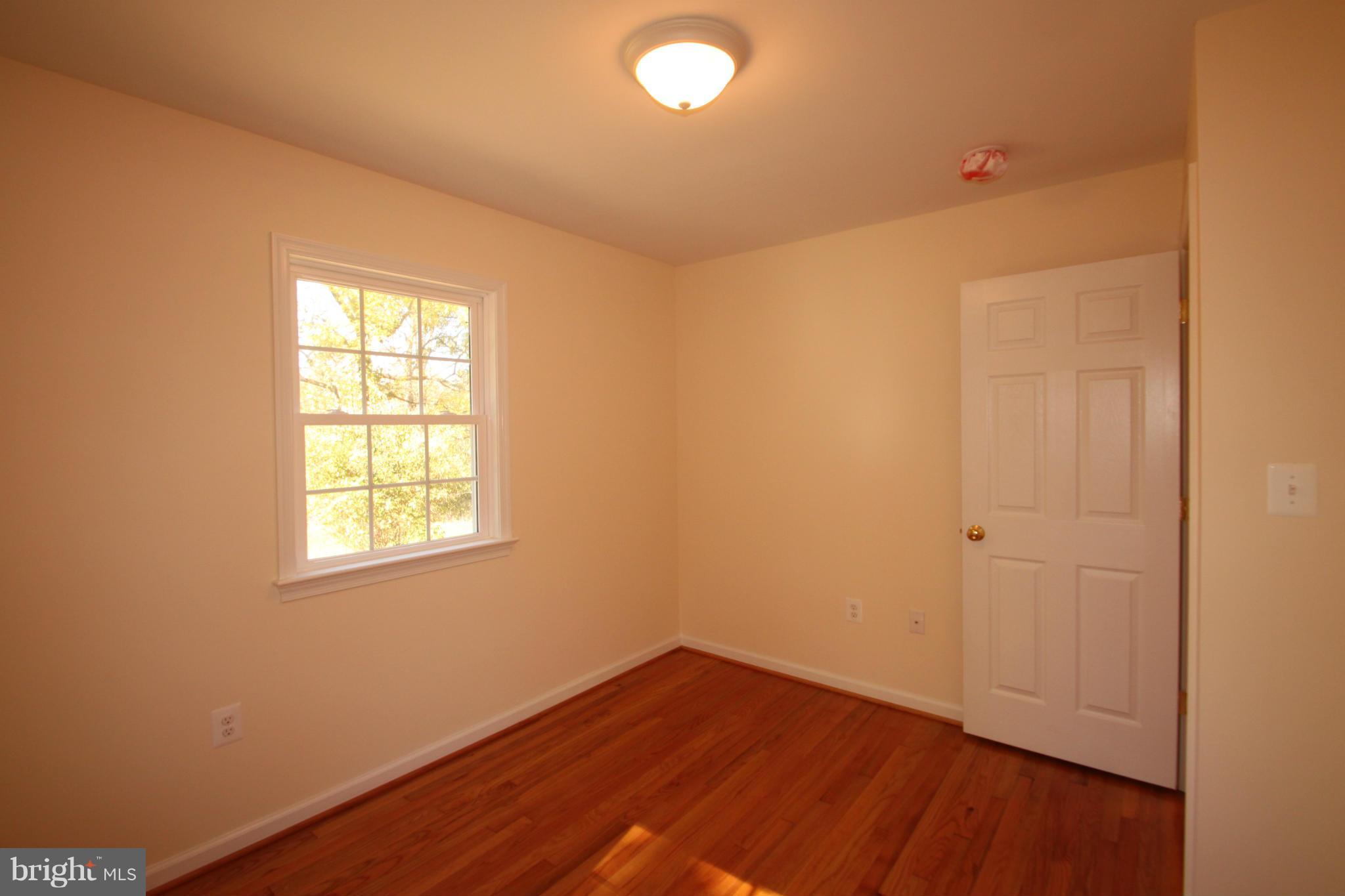 14394 Shanktown Road Reva, VA 22735 - Photo 15 of 18 an empty room with wooden floor and windows