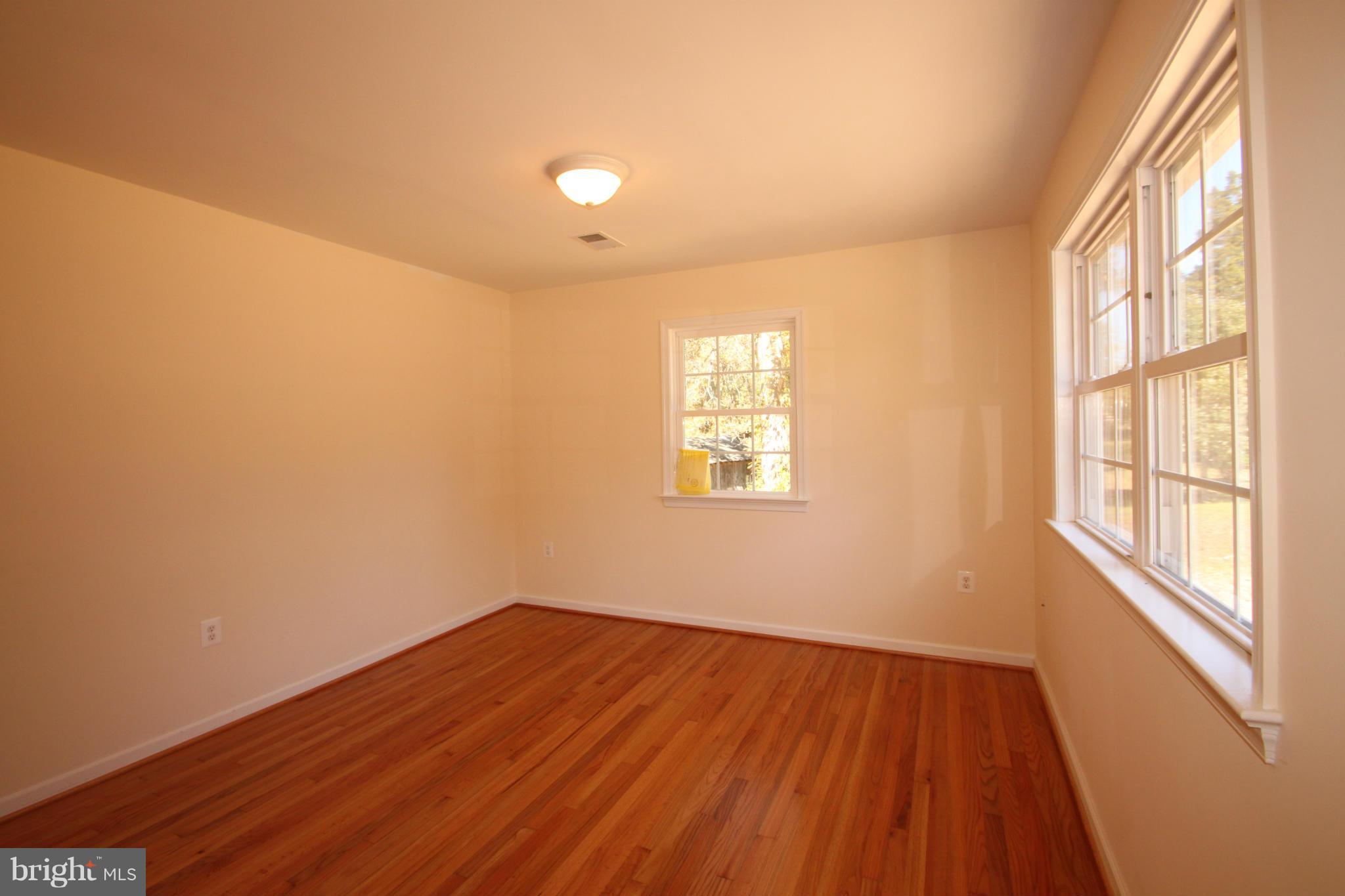 14394 Shanktown Road Reva, VA 22735 - Photo 3 of 18 an empty room with wooden floor and windows