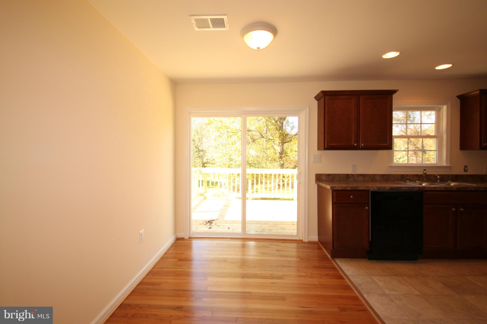 14394 Shanktown Road Reva, VA 22735 - Photo 5 of 18 a kitchen with granite countertop a refrigerator and a stove top oven