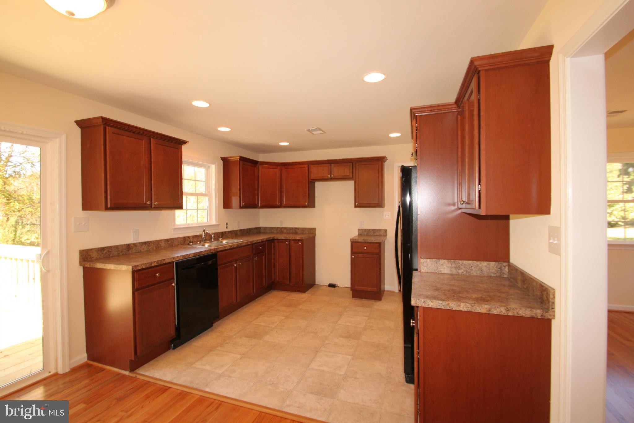 14394 Shanktown Road Reva, VA 22735 - Photo 6 of 18 a large kitchen with stainless steel appliances granite countertop a refrigerator and a sink