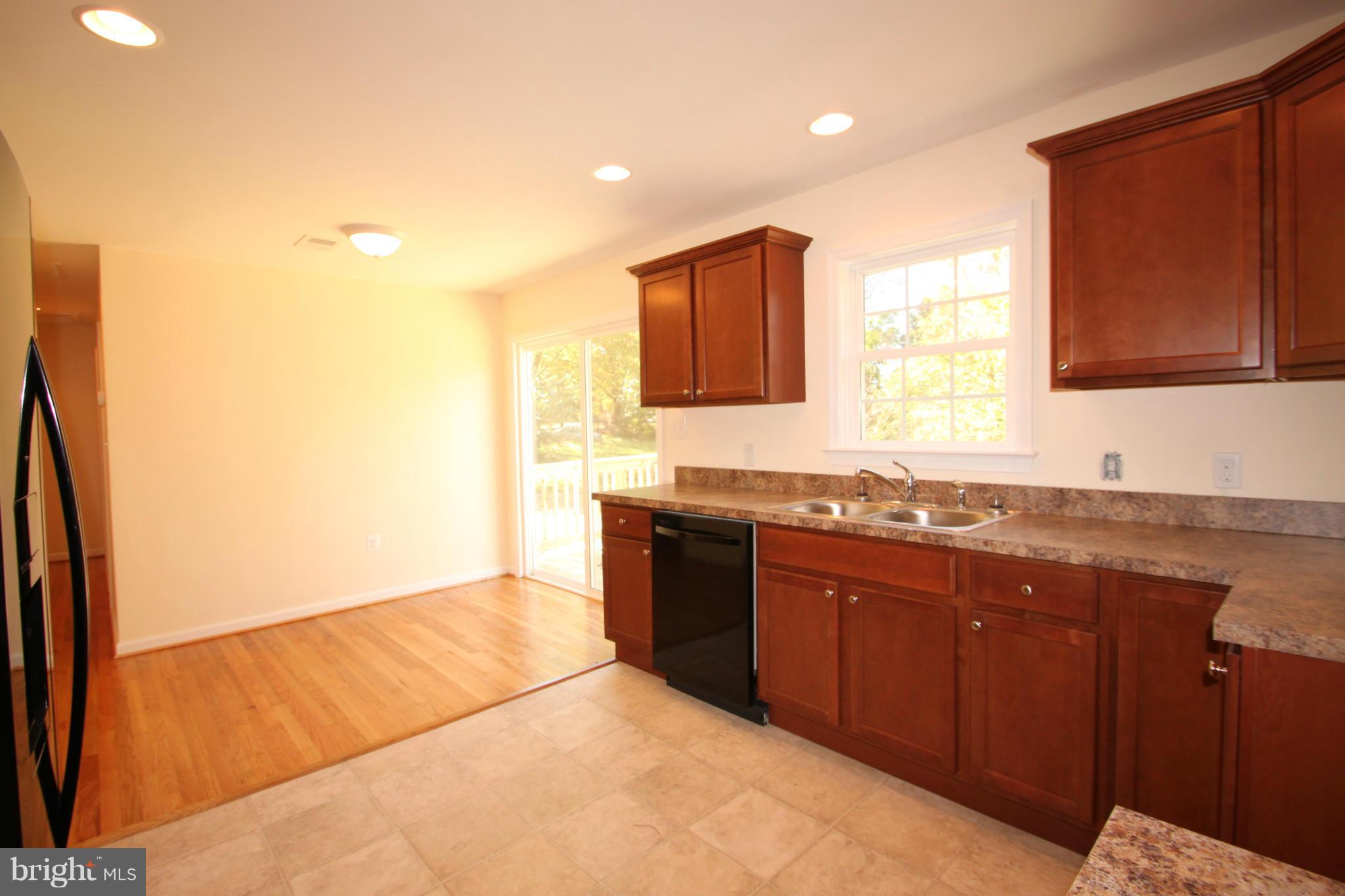 14394 Shanktown Road Reva, VA 22735 - Photo 8 of 18 a large kitchen with granite countertop a sink and a stove