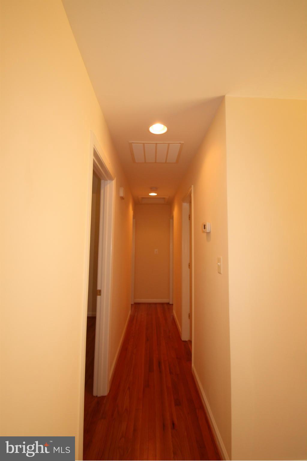 14394 Shanktown Road Reva, VA 22735 - Photo 9 of 18 a view of a hallway with wooden floor