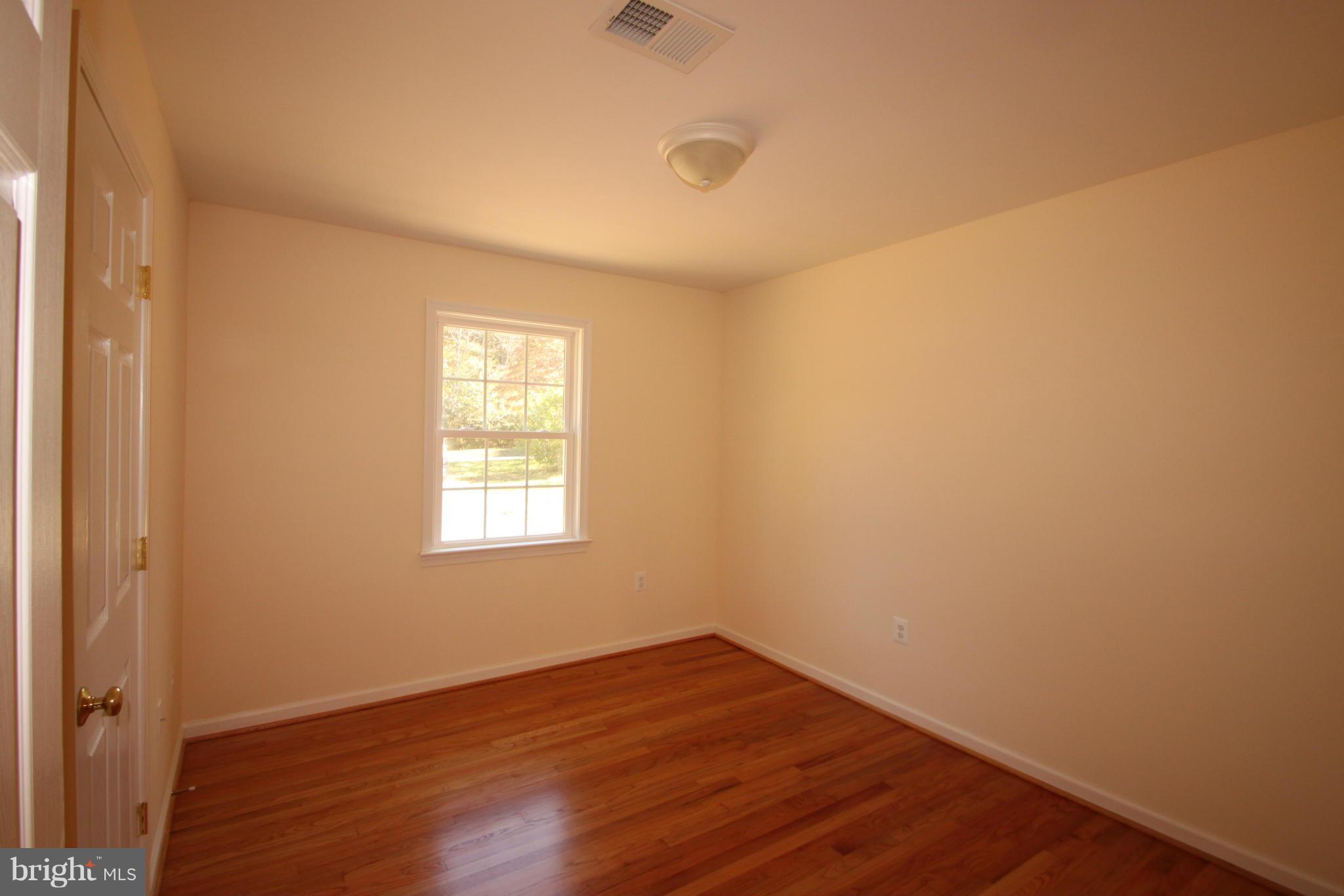 14394 Shanktown Road Reva, VA 22735 - Photo 10 of 18 a view of an empty room with wooden floor and a window