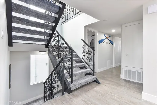 a living room with furniture a chandelier and a window