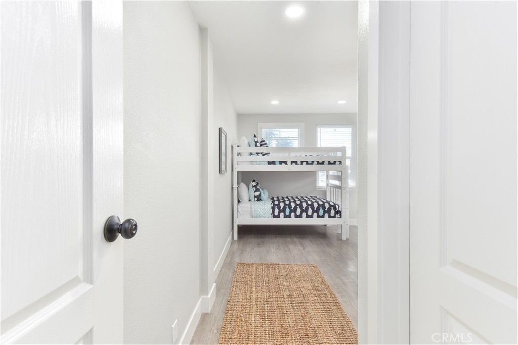 16791 Bayview Drive Huntington Beach, CA 90742 - Photo 28 of 75 a view of a hallway with wooden floor and cabinet