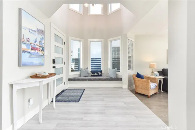 a living room with furniture a fireplace and a chandelier