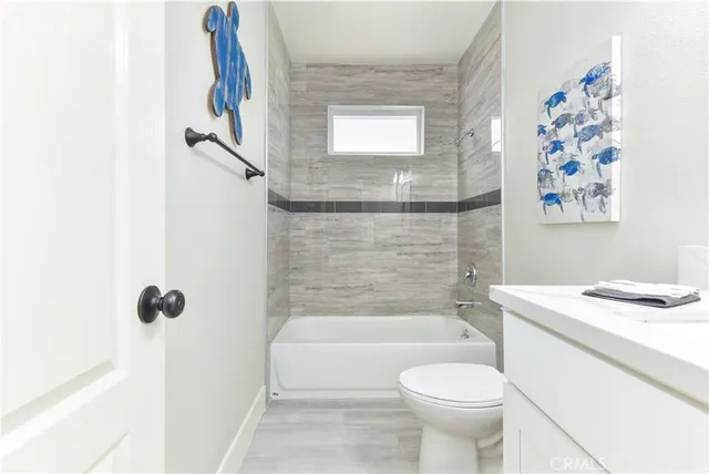 a bedroom with a large bed and wooden floor