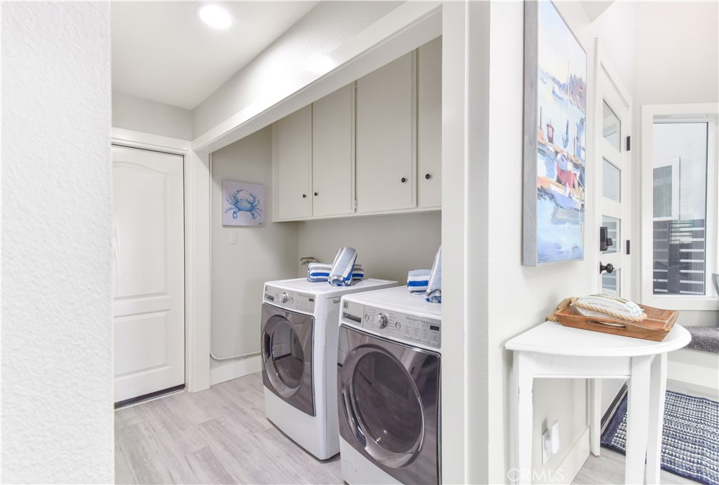 16791 Bayview Drive Huntington Beach, CA 90742 - Photo 33 of 75 a view of a storage & utility room with washer and dryer
