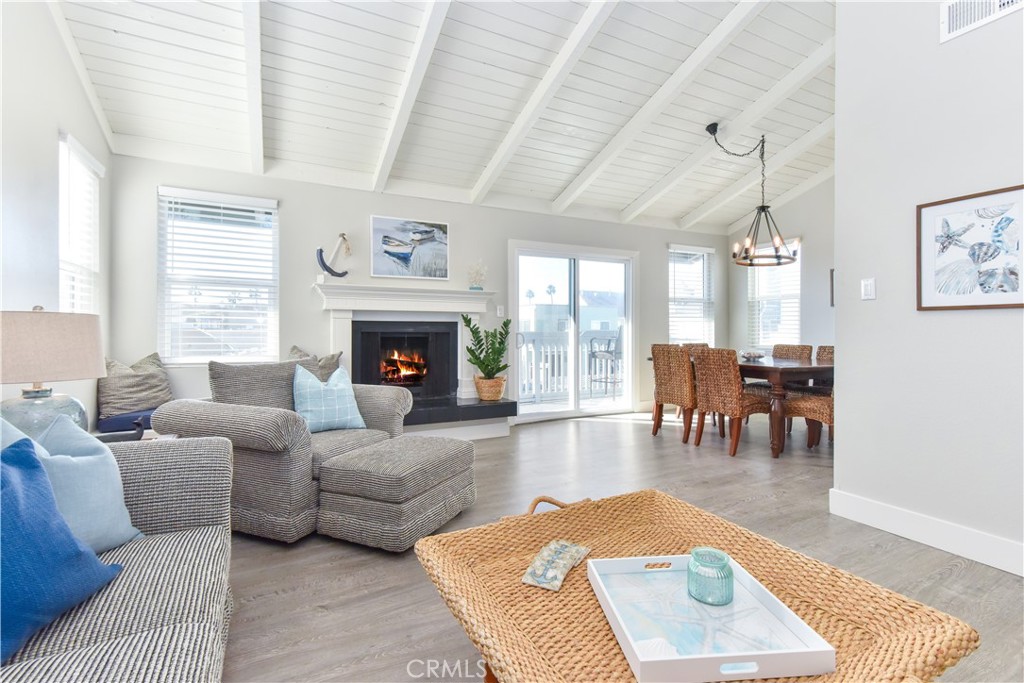 16791 Bayview Drive Huntington Beach, CA 90742 - Photo 39 of 75 a living room with furniture a rug a fireplace and a large window