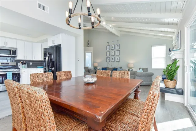 a view of staircase with lots of frames on wall and a window