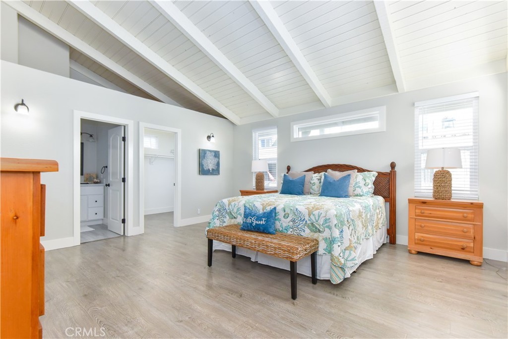 16791 Bayview Drive Huntington Beach, CA 90742 - Photo 5 of 75 a spacious bedroom with a bed and a chandelier