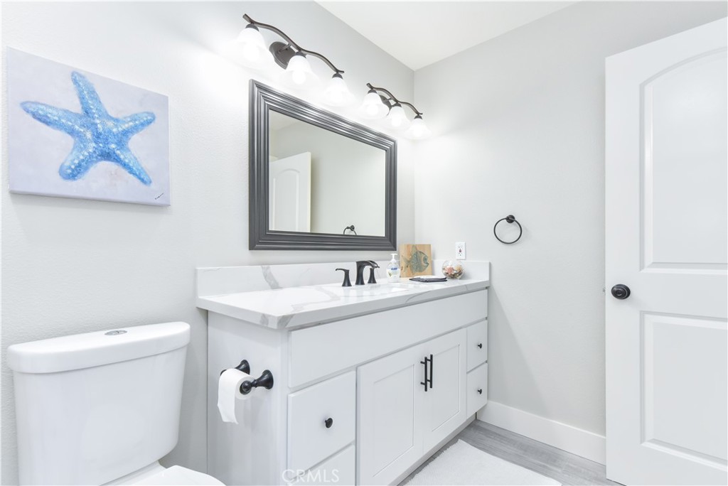 16791 Bayview Drive Huntington Beach, CA 90742 - Photo 57 of 75 a bathroom with a toilet sink and mirror