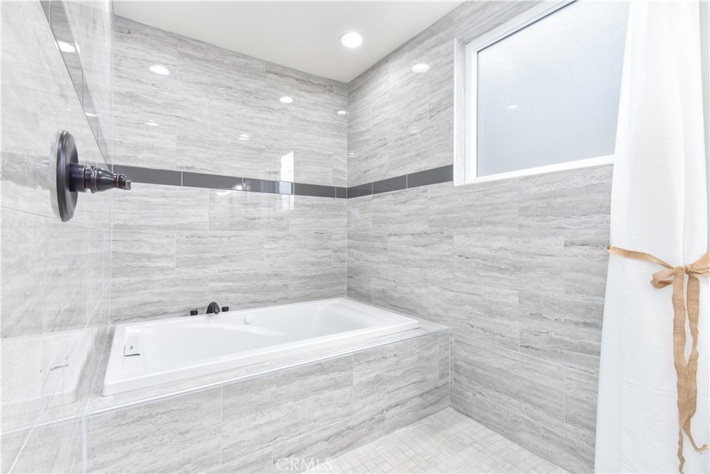 16791 Bayview Drive Huntington Beach, CA 90742 - Photo 58 of 75 a bathroom with a bathtub