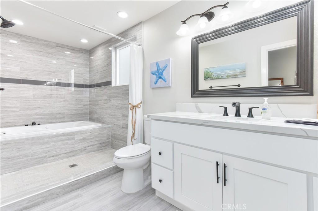 16791 Bayview Drive Huntington Beach, CA 90742 - Photo 6 of 75 a bathroom with a sink a toilet and a bathtub