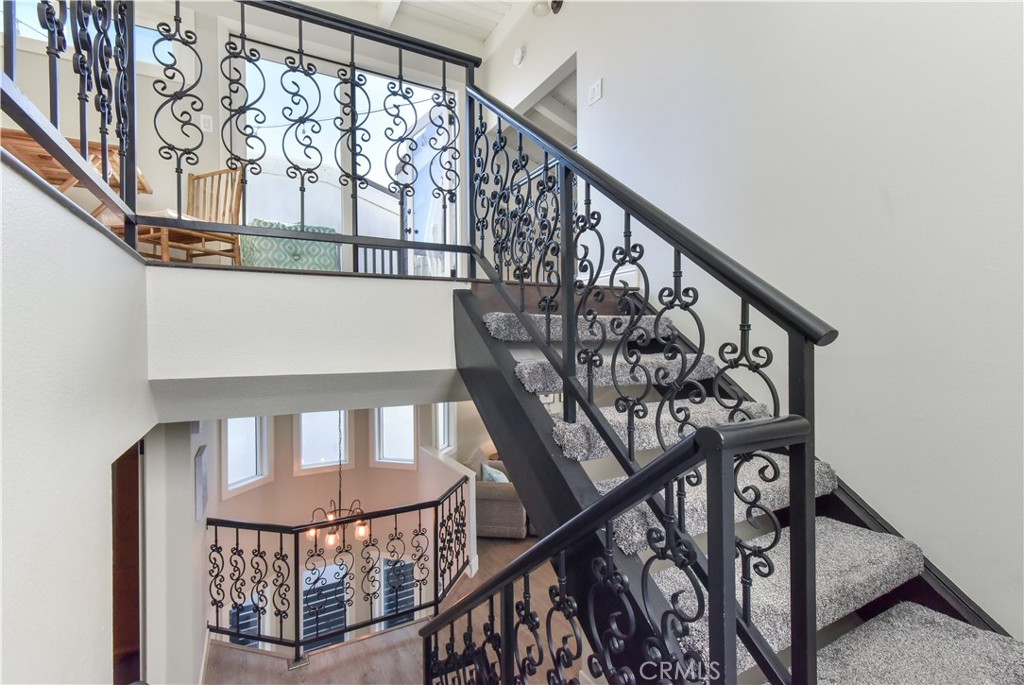 16791 Bayview Drive Huntington Beach, CA 90742 - Photo 61 of 75 a view of staircase with lots of frames on wall and a window