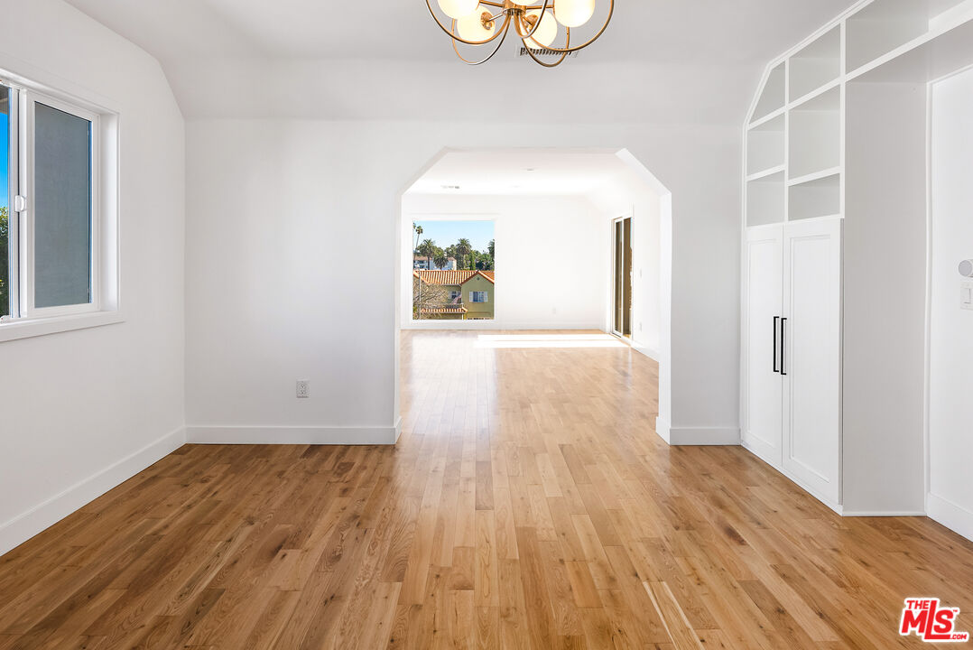 1253 South Rimpau Boulevard Los Angeles, CA 90019 - Photo 18 of 71 a view of a room with wooden floor and window