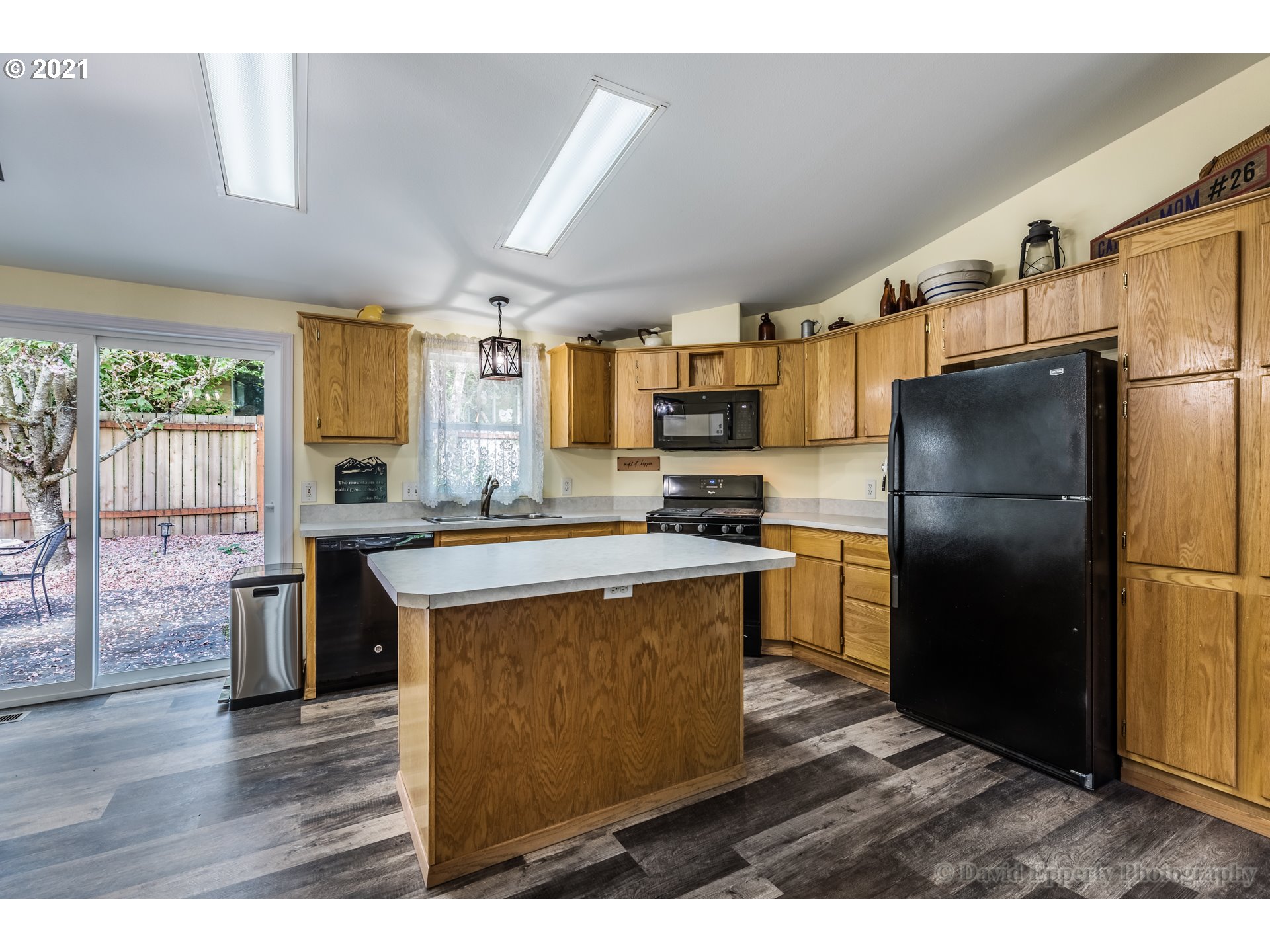 75040 Lewis Road Rainier, OR 97048 - Photo 6 of 22 a kitchen with a refrigerator a stove a sink dishwasher and wooden cabinets with wooden floor