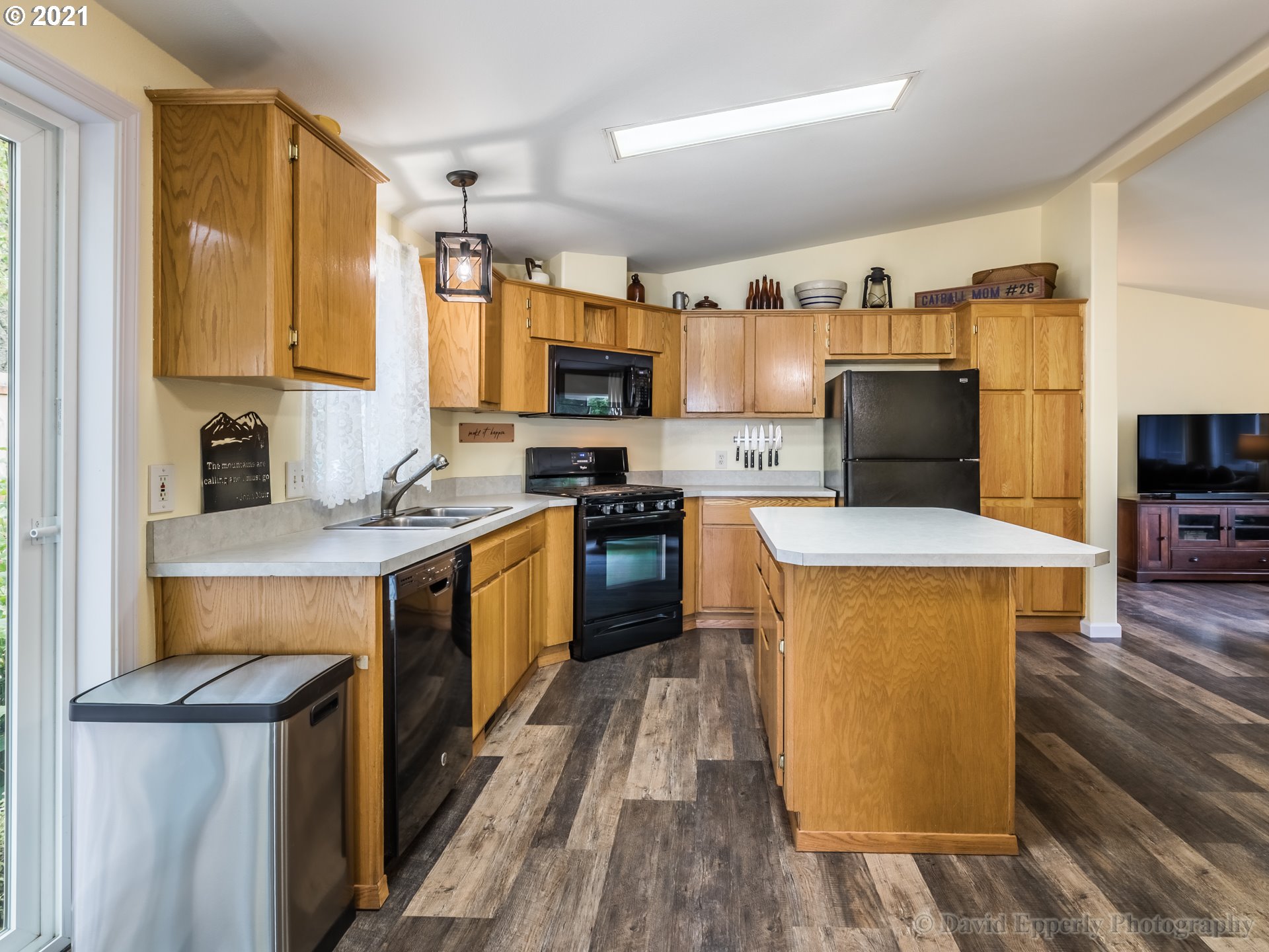 75040 Lewis Road Rainier, OR 97048 - Photo 7 of 22 a kitchen with stainless steel appliances granite countertop a stove top oven a sink dishwasher and a refrigerator with wooden floor