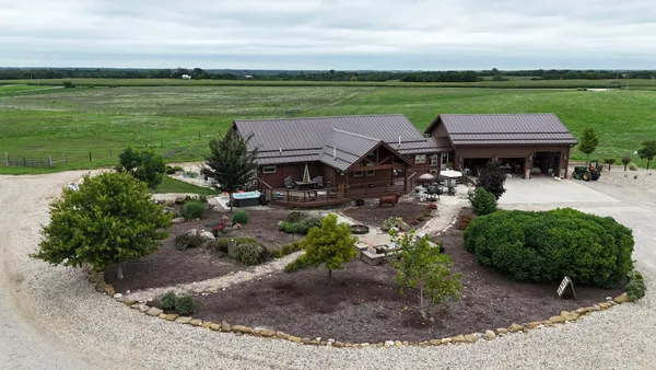 a view of a lake with a big yard and potted plants