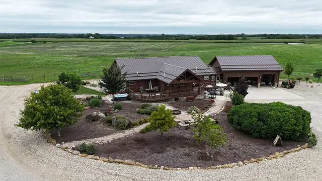 a view of a lake with a big yard and potted plants