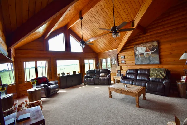 a living room with furniture a couch and dresser with exposed radiator