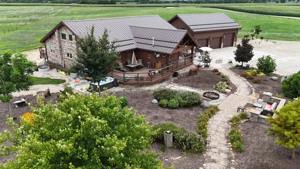 an aerial view of a house with garden space and street view