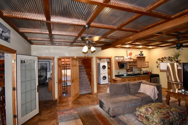 a living room with furniture and a chandelier