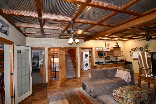 a living room with furniture and a chandelier