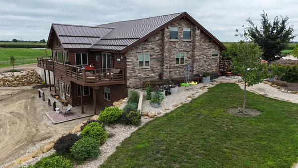 a front view of house with yard and green space