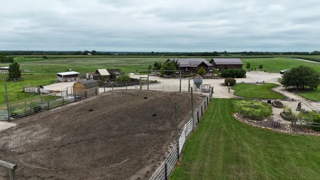 an aerial view of a backyard with chairs
