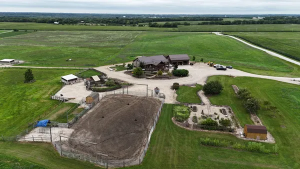 an aerial view of a house with outdoor space and lake view