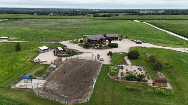 an aerial view of a house with outdoor space and lake view