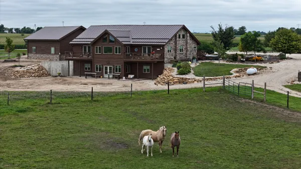 a front view of house with outdoor seating and yard