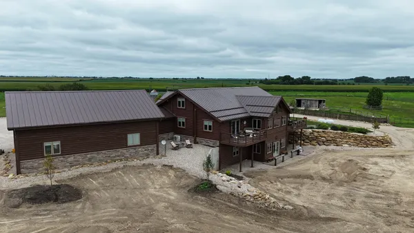 an aerial view of a house with a lake view