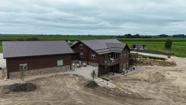 an aerial view of a house with a lake view