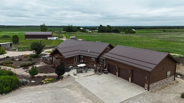 an aerial view of a house with garden space and street view