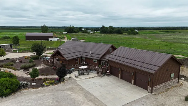 an aerial view of a house with garden space and street view